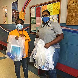 Adrian Giron, director of the Boys and Girls Club of Opelousas, receives a donation of 4-H Healthy Habits activity bags from Kayla Fontenot, youth development agent, on July 13, 2020.