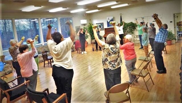 Participants in the LIFT program at the Troy-Montgomery County Senior Center kick off their class with strength building exercises using hand-held weights.
