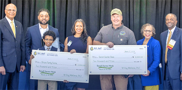 Group photo of small farmers receiving checks.
