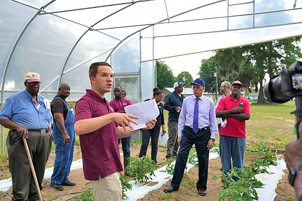 Dr. Brandon Huber speaks to participating farmers during a high tunnel workshop.