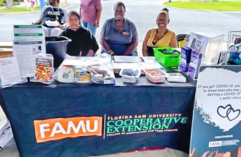 Youth volunteers Lillian Leland, Kimberly Davis and Dr. Dreamal Worthen.
