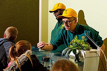 Dr. Ken Thompson provides a hands-on aquaculture activity for students at an Extension event.