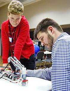Walter Malone, Extension agent III for Sullivan County in Tennessee, works with a student during a meeting of the teen tech club conducted in partnership with local public libraries.