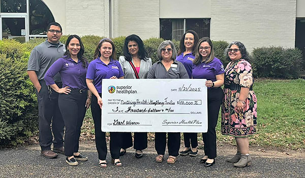 Group holding a check.