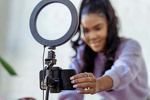 Young girl adjusting camera.