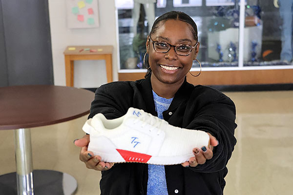Dr. LaPorchia Davis with her Tumble Tamer shoe prototype.