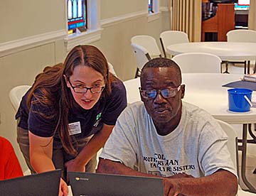 Tech Changemakers work on a computer.