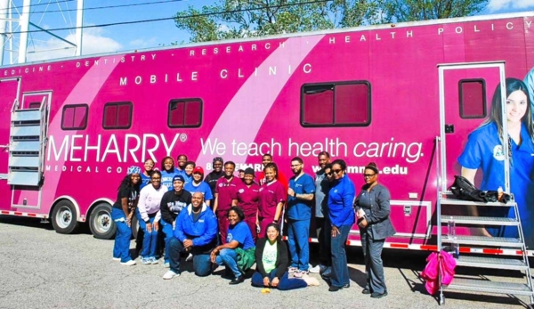 People in front of mobile health unit.