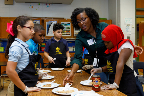 Turquoise Brown helps students cook.
