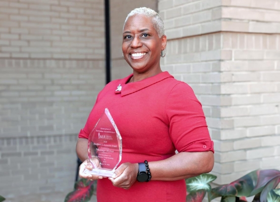 Nkenge Hyter holds her award.