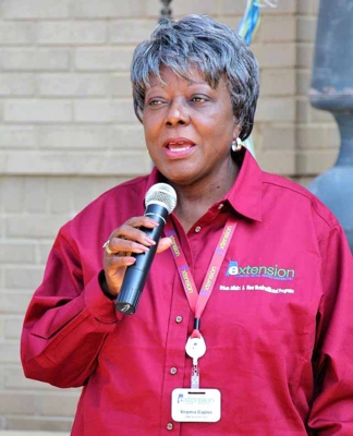 Dr. Virginia Caples speaks into a microphone.