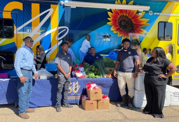 Southern University Ag Center staff members prepare for the produce giveaway in front of the M-TEC Unit.