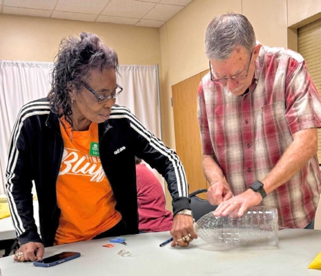 Demonstration participants work on their worm composting jugs.