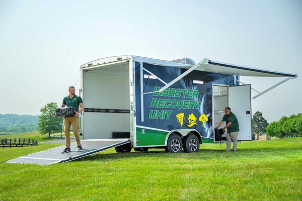 Kentucky State employees Cameron Sellers and Gill Finley stock the Disaster Recovery Unit.