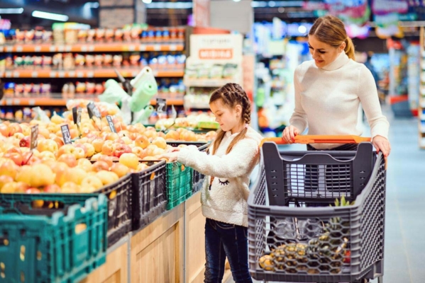 Mom and daughter shop at the grocery store.