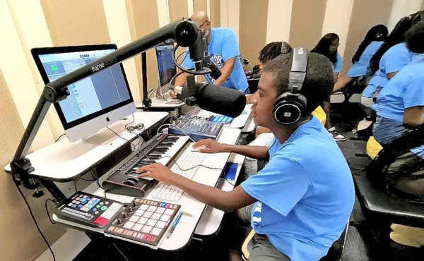 Middle and high school students learn how to produce beats.
