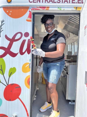 FCS Program Leader Renita Porter serving healthy food from the CSU Extension Mobile Food Kitchen.