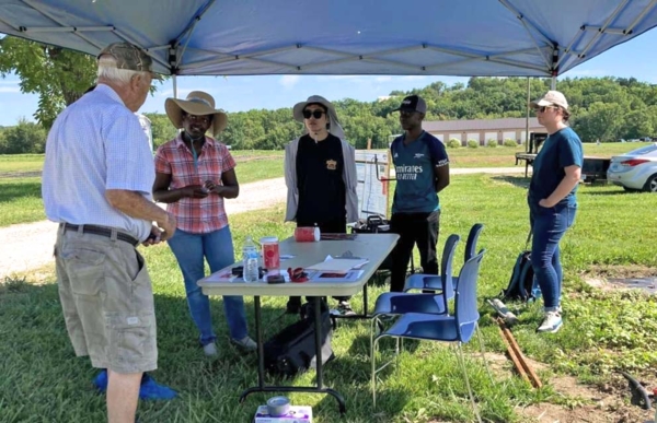 Dr. Kaluwasha speaking with visitor at Carver Farm Field Day.