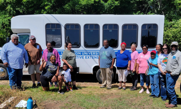 Community members stand together for a group photo.