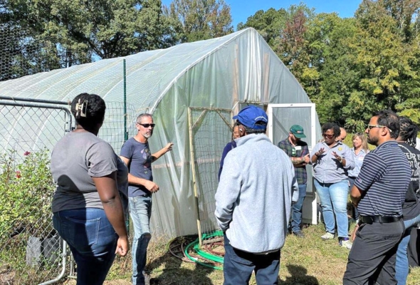 Group gather on farm.