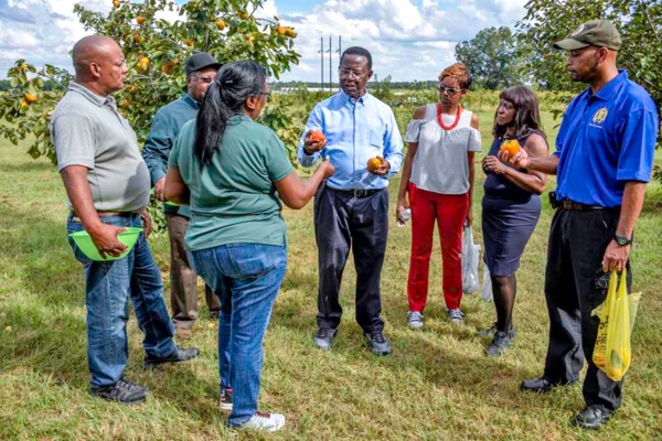 Dr. James Brown speaks to a group at organic farm on campus.