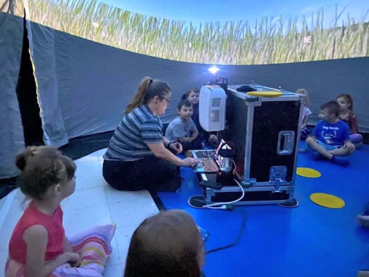 Students engage in the StarLab.