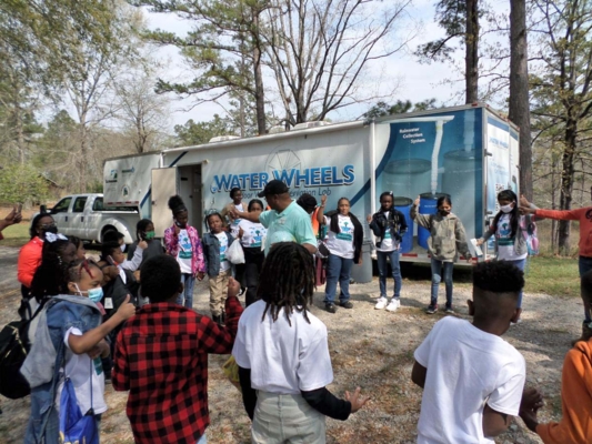 Students gather near the Water Wheels mobile unit.