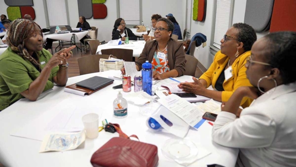 Dr. Sandra Thompson engages with local business owners and program participants.