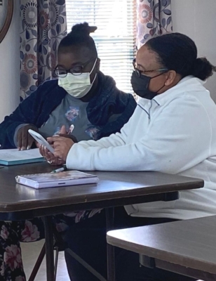 Adrienne Hunter-Green works with a participant on entrepreneur endeavors.