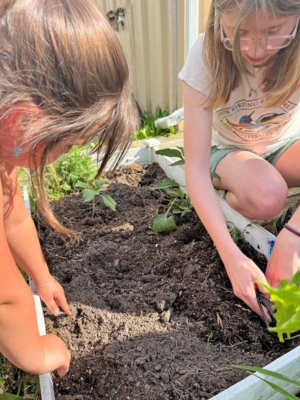 Emily Carothers works with youth in the soil.