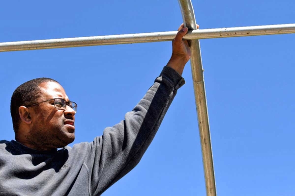 Berran Rogers lends a hand at the raising of a hoop house for a small farmer.