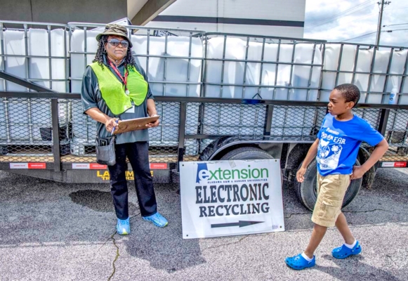 Extension staff and youth at recycling site.