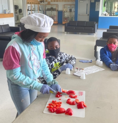 Zamiya Marrow dices red bell peppers for a crispy taquitos recipe.   