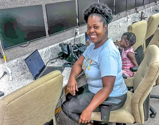 Woman and child working on computers.