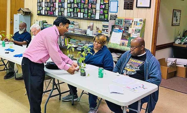 Community members practice gardening skills.