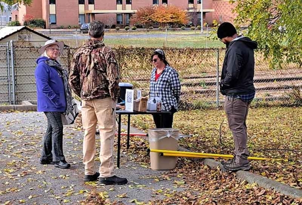 Group standing outside surrounded by leaves.