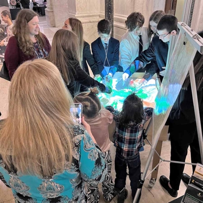 Youths engaging with the sandbox.