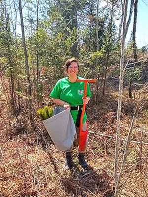 Eden Clymire-Stern working in a forest.