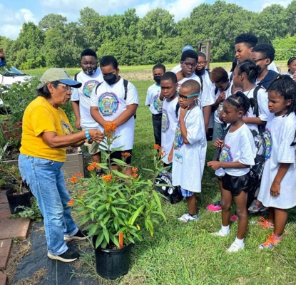 Mila Berhane teaches campers about pollinator gardens.