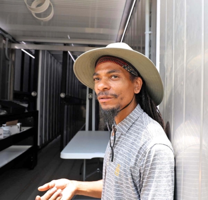 Dr. Harold Higgins showing the inside of the Hydroponics Shipping Container.