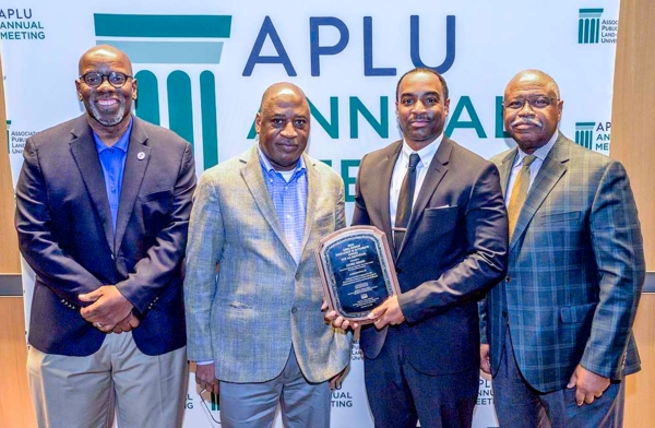 Dr. Cedric Ogden holds award while standing next to Fort Valley State University leadership.