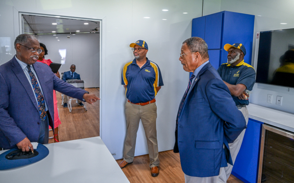 Congressman Sanford Bishop Jr. visits with Extension leaders to tour the new mobile unit.