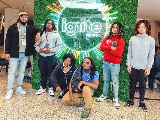 Students gather in front of Ignite by 4-H backdrop.