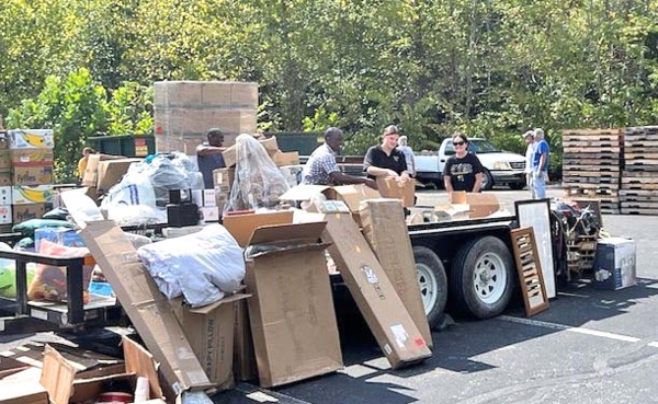 Group with free items in parking lot.