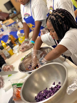 JAGcation campers learn to cook red cabbage coleslaw.