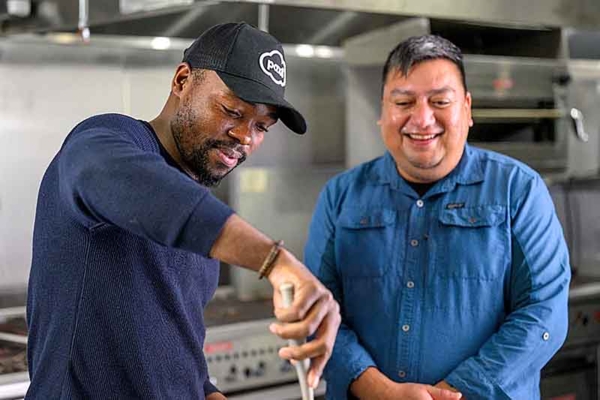 Graduate student Uchechukwu Ohajiudu and Dr. Noel Novelo prepare meals with Kentucky State-produced tilapia.