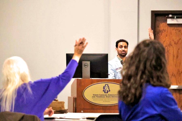 Biswanath Dari, Ph.D., speaks with a participant during a workshop.