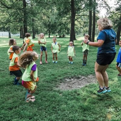 Happy Raffaele and a group of kids from Lawrenceburg, Kentucky, do jumping jacks.
