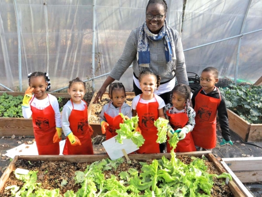 Dr. Virginie Zoumenou work with youths in the garden.