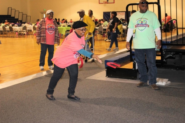 Senior woman plays a game of horseshoes.